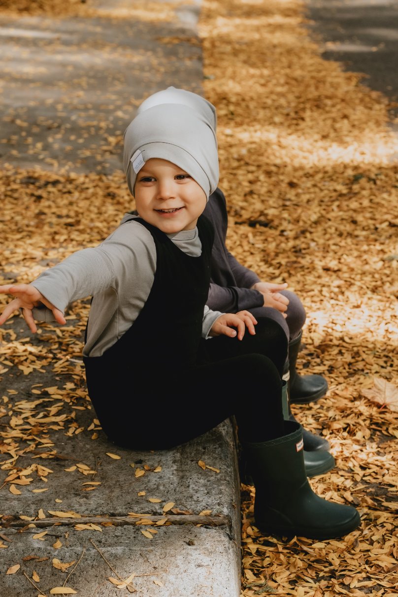 Soft and stretchy taupe beanie for kids, made from eco-friendly fabric. Ethically crafted in Canada, featuring a fold-over brim and minimalist design